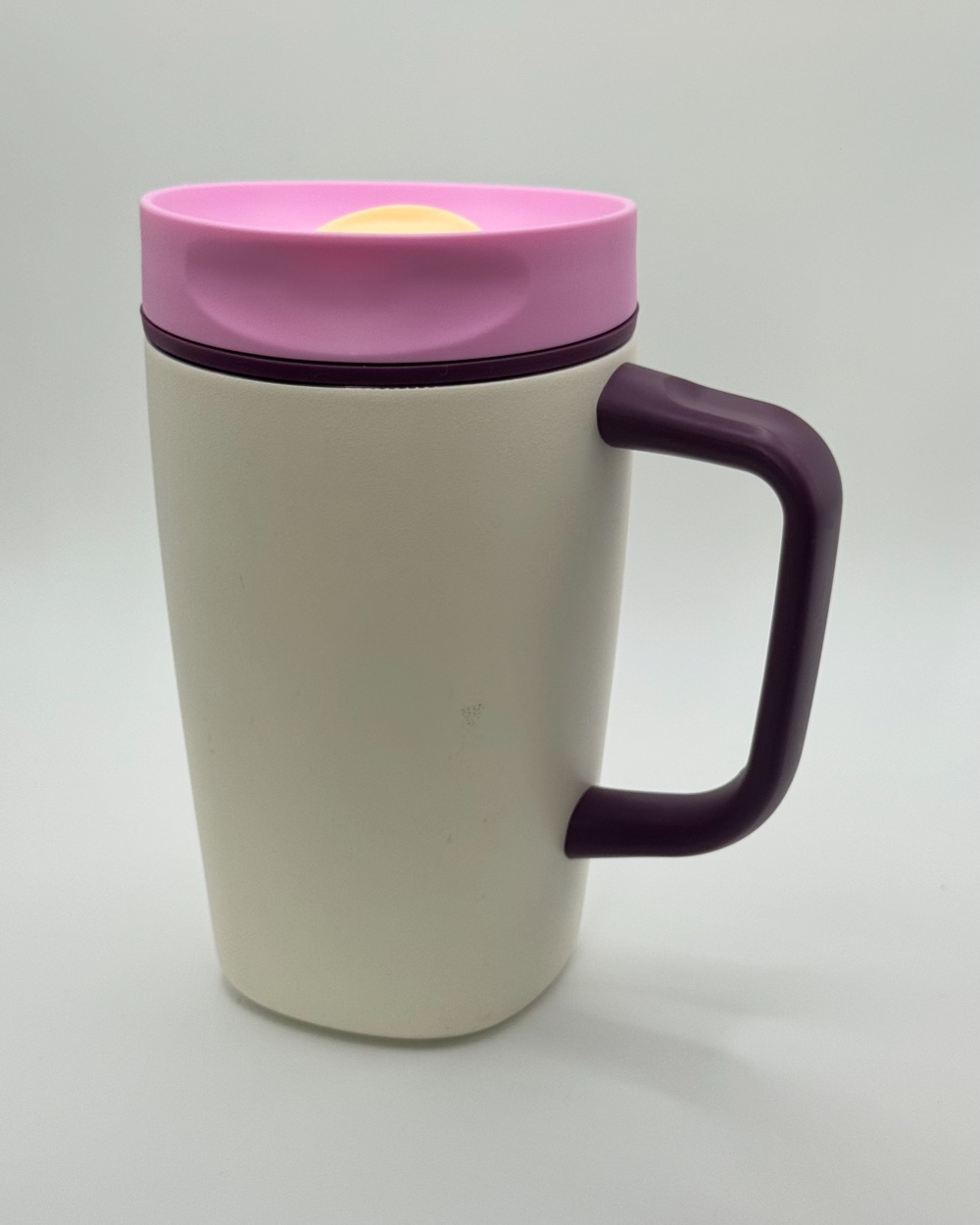 Cream Owala coffee cup with a pink lid